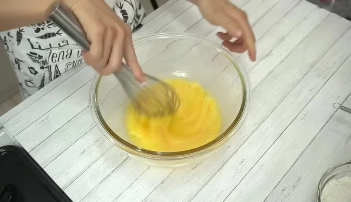 Add milk to the egg mixture and mix well. Gradually add sifted flour, mixing carefully to avoid lumps. Pass the batter through a strainer for a smooth consistency.
