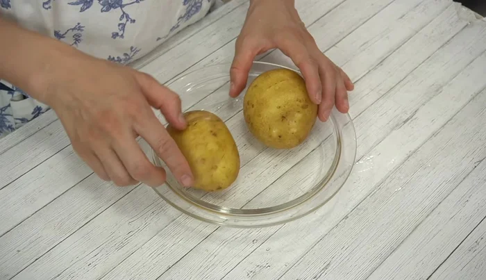 Wash potatoes thoroughly and place them on a heat-resistant plate. Cover tightly with wet kitchen paper and plastic wrap.