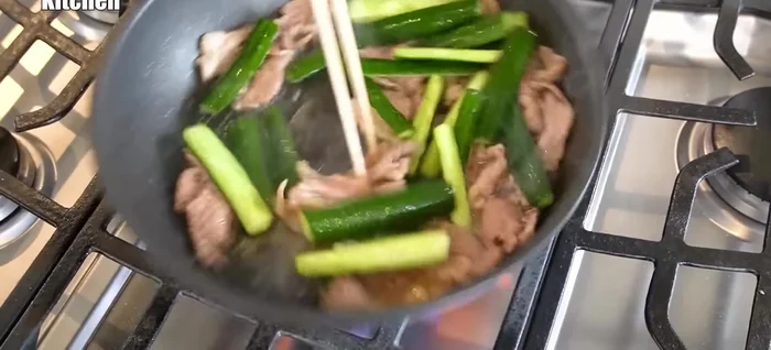 Add the salted and drained cucumbers to the pan. Stir-fry over high heat to maintain crispness.