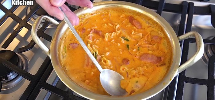 Top with cheese and simmer briefly.