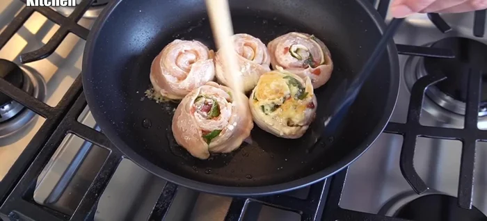 Flip the chicken rolls and continue baking (340.86).