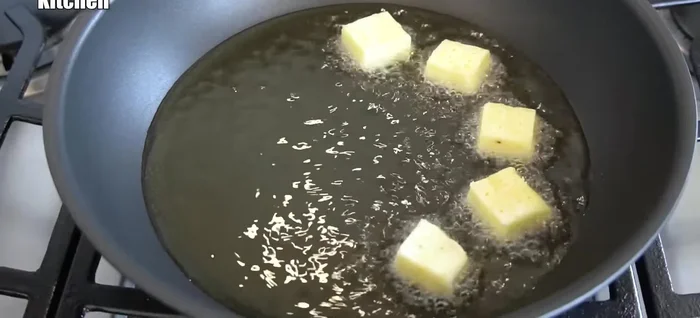 Fry the potato pieces in a pan with oil over medium-low heat until golden brown on both sides.