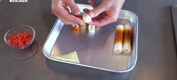 Stuff the cheese and pickled ginger into the chikuwa pieces.