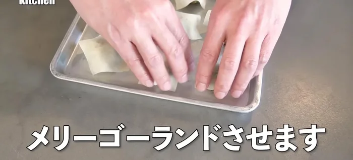 Using both hands, rotate the shumai skin around the meatball to form a bun shape.