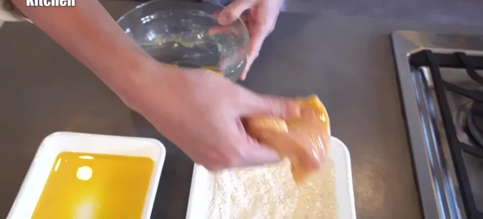 Coat the chicken generously in the flour mixture, ensuring complete coverage. Then, dip the chicken into the remaining egg mixture, followed by another coating of the flour mixture for a double-batter effect.