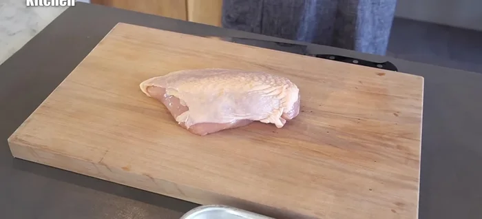 Cut the chicken breast into three large pieces, following the natural fibers to prevent dryness. Gently pound the surface of each piece to soften the meat and create jagged edges for better spice and batter adhesion.