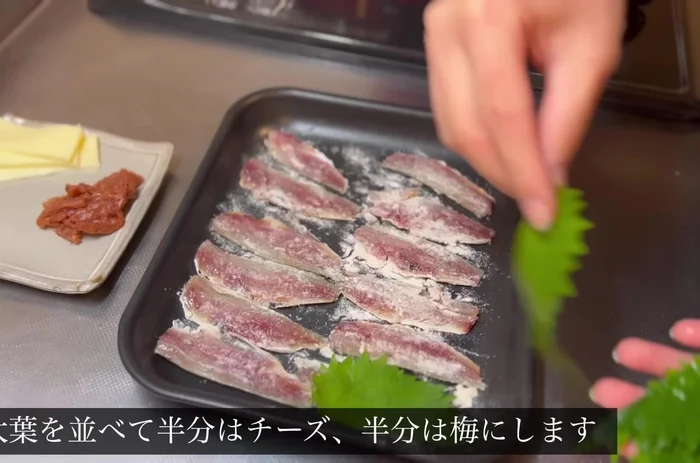 Arrange sardines, put cheese on one half and plum on the other, roll up, and stick a toothpick in.
