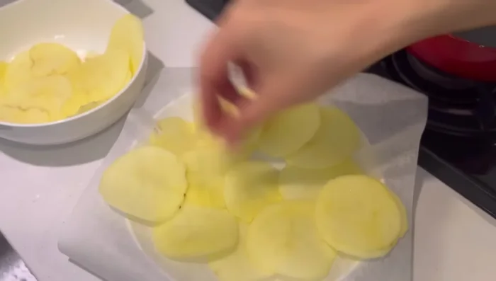 Arrange potato slices on a cooking sheet, ensuring they don't overlap. Microwave for 7 minutes (adjust time as needed).