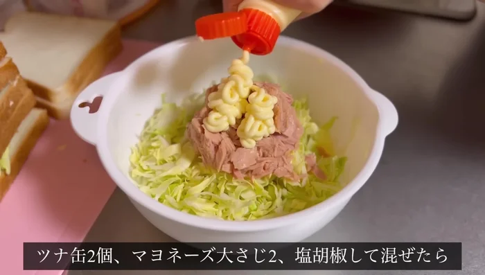 Make tuna cabbage sandwiches: Mix canned tuna, mayonnaise, salt, and pepper. Layer the mixture between bread slices.