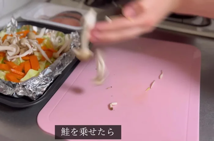Place salmon on top of vegetables.