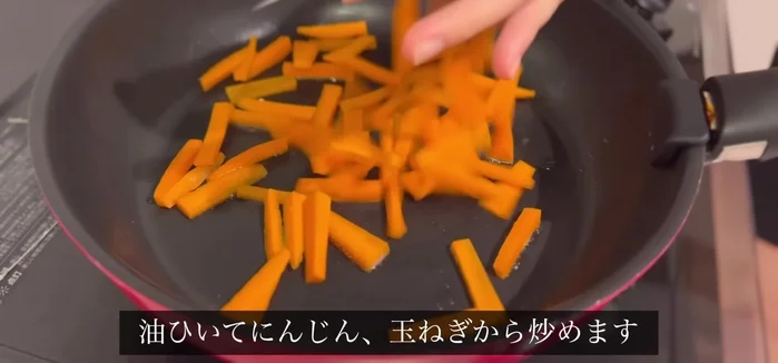 Add oil to the frying pan and fry the carrots and onions until soft.