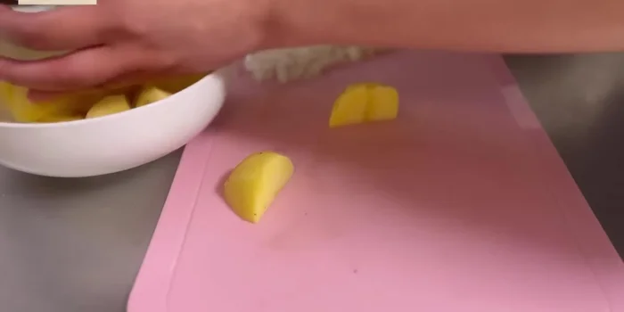 Mash the cooked onions with a spoon.