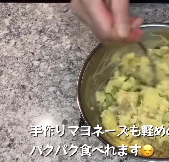 Potato Salad preparation: Combine boiled and mashed potatoes with mayonnaise and seasonings.