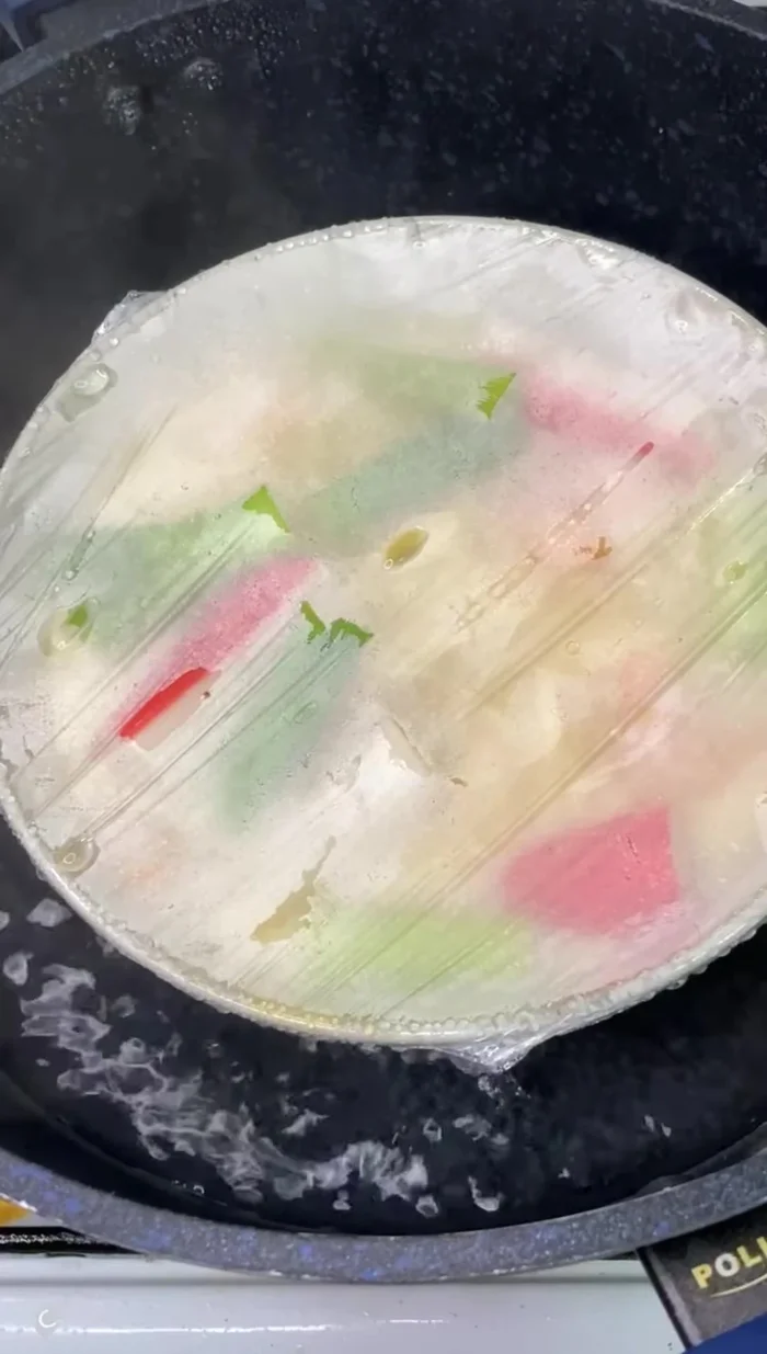 After 12-15 minutes, turn off the heat and carefully remove the plastic wrap, being careful not to burn yourself.