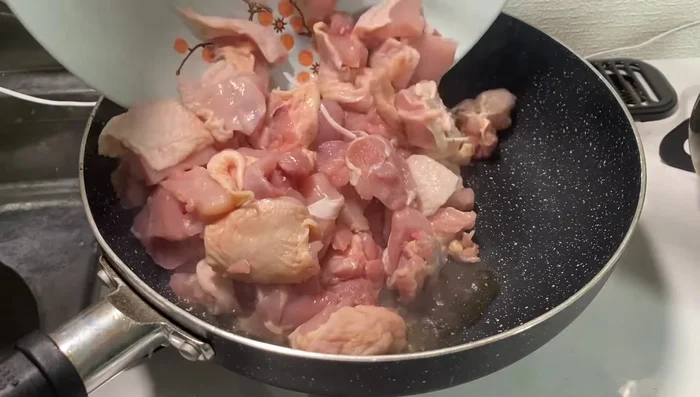 Add more oil to the pan and add the chicken, stir-frying until browned.
