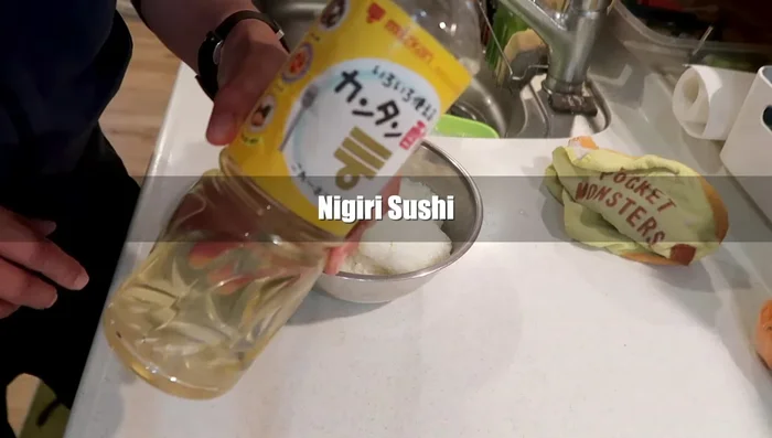 Prepare sushi rice by mixing with sweet vinegar.