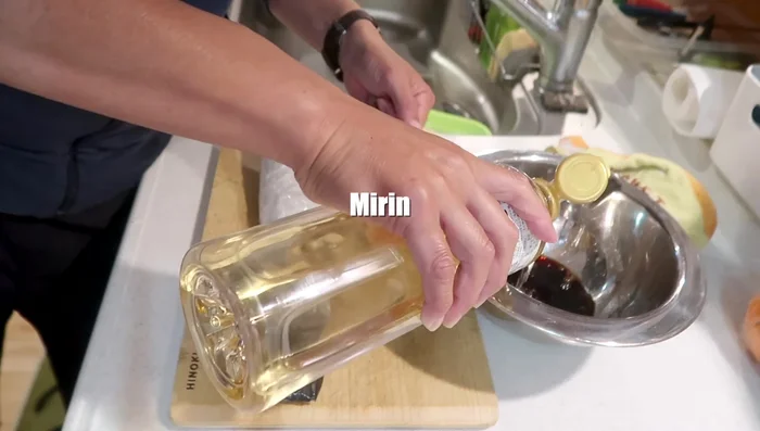 Make a marinade sauce using soy sauce, sesame oil, ground sesame seeds, and dashi.