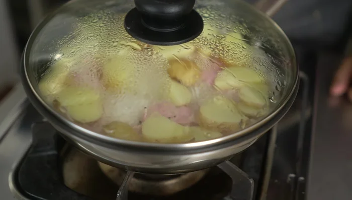 Reduce heat to low and simmer for 10 minutes. Then, increase heat briefly for 10 seconds (or longer for browner rice).