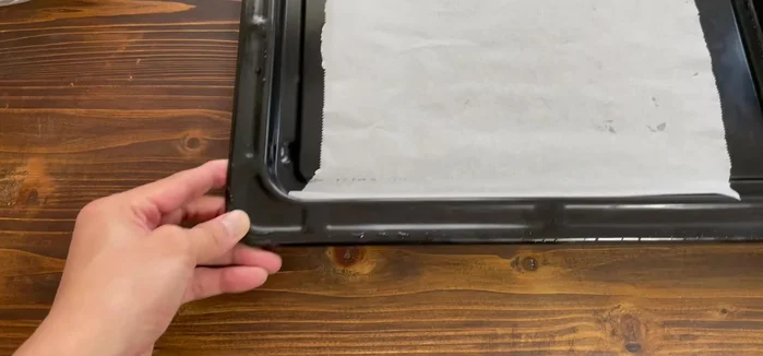 Place a sheet of baking parchment paper in the oven.