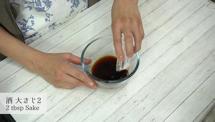 Prepare the ginger sauce by mixing soy sauce, sake, mirin, sugar, and grated ginger.