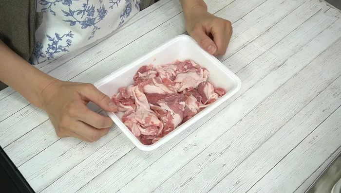 Coat the marinated pork with flour to seal in juices and help the sauce adhere.