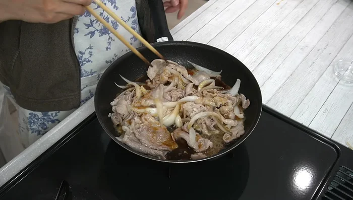 Pour the prepared ginger sauce over the pork and onions. Increase the heat to medium-high and simmer for at least one minute to evaporate the alcohol.
