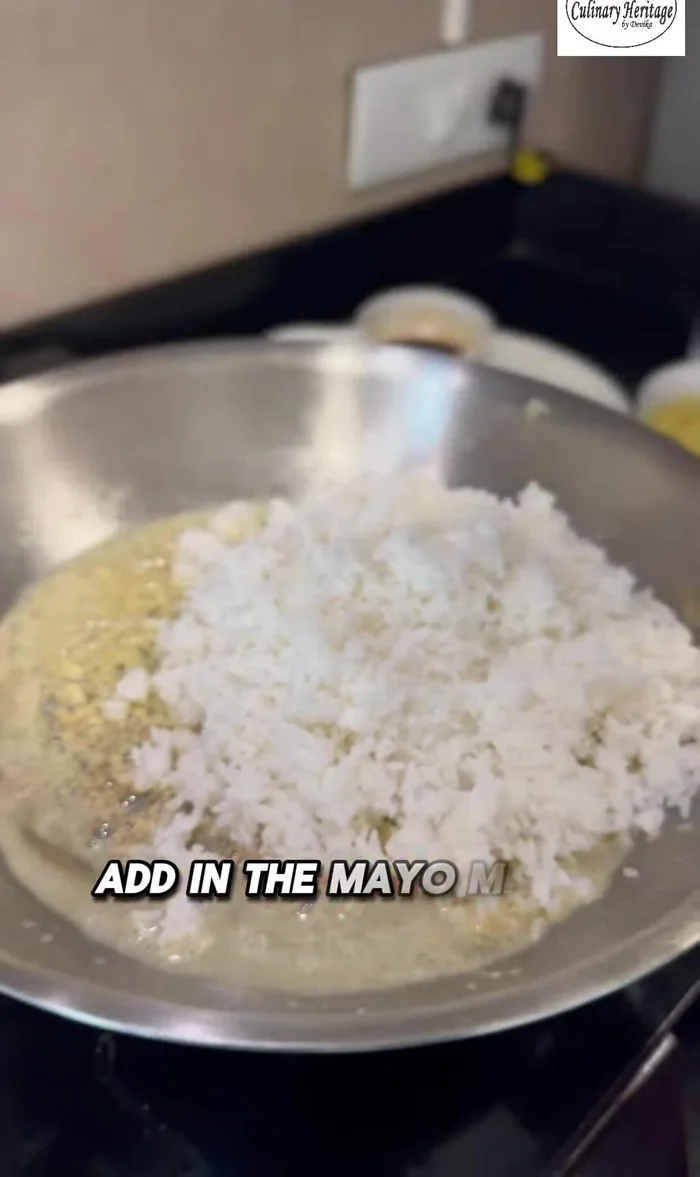 Add the mayo-mixed rice to the pan. Sprinkle with salt, black pepper, and dark soy sauce.