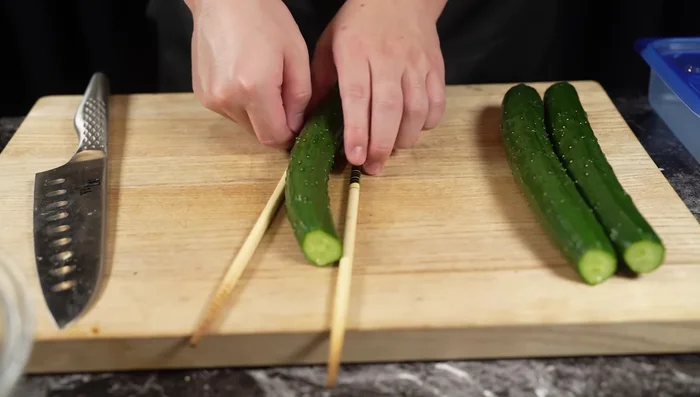 Cut cucumbers accordion-style, using chopsticks to prevent cutting all the way through.