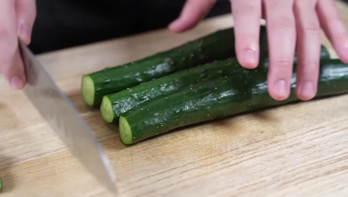Cut cucumbers into irregular chunks, removing stems.