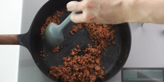 Stir-fry until the liquid burns off and the meat browns, caramelizing the aromatics. Aim for a good maillard reaction without burning.