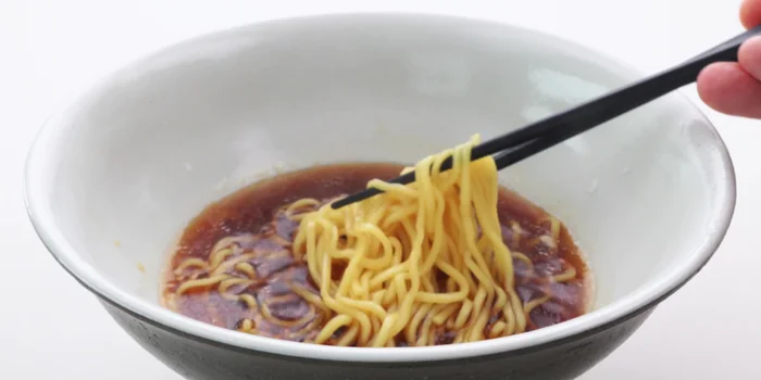 Stir noodles and broth. Arrange toppings (chicken chashu, menma, narutomaki, ramen egg, scallions) on top.