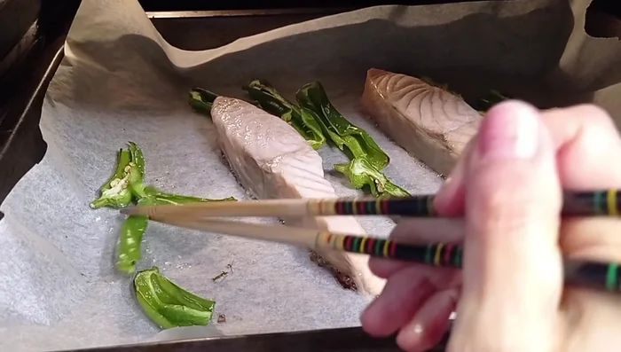 Bake for 6-7 minutes, then flip the salmon and peppers. Continue baking for another 3-5 minutes.