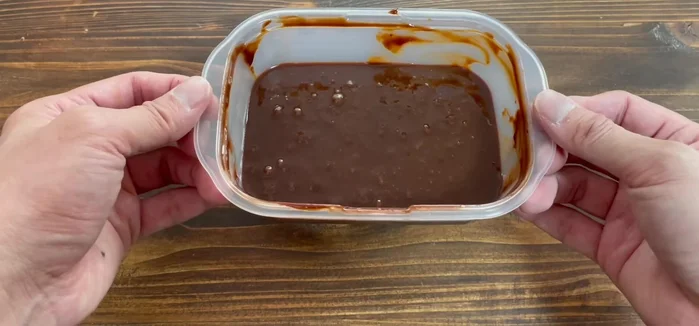 Tap the Tupperware container to remove air bubbles.