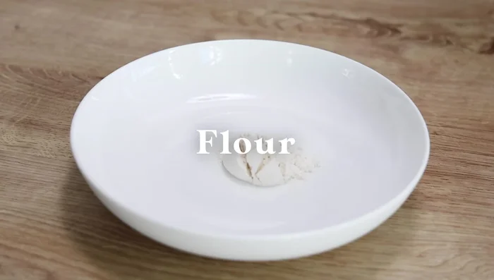 Make the batter: Mix flour, garlic powder, salt, pepper, and water in a bowl.