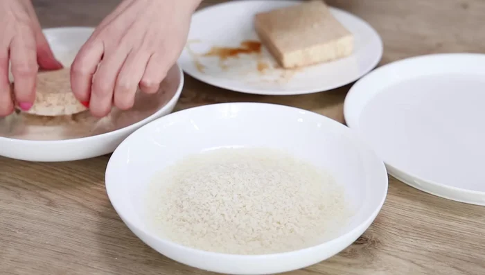 Place panko breadcrumbs in another bowl. Dip the tofu in the batter, then coat with panko breadcrumbs.