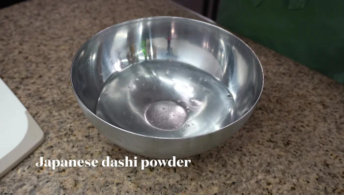 Make the sauce: In a bowl, combine water, Japanese dashi powder, soy sauce, and sesame oil. Mix well.