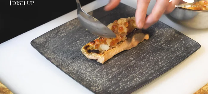 Plate the grilled salmon, topping with the daikon and salmon roe mixture.