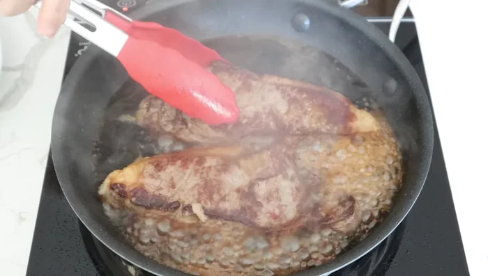 Pour soy sauce mixture over the steak and cook for 1 minute, coating well.