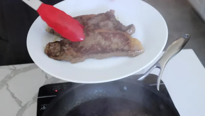 Remove steak and let it rest. Reduce the sauce slightly in the pan, then add butter. Stir and remove from heat.