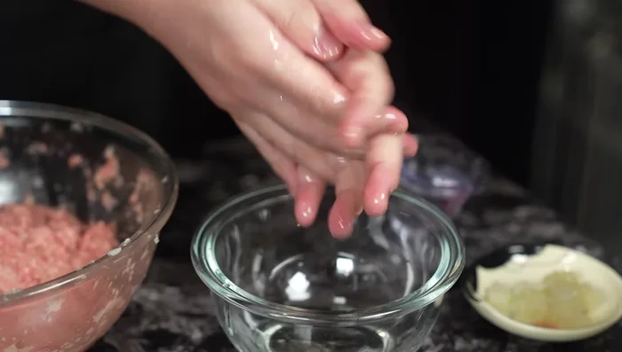 Oil your hands to prevent sticking. Shape the meat mixture into two patties, about 2cm thick, tapping out excess air.