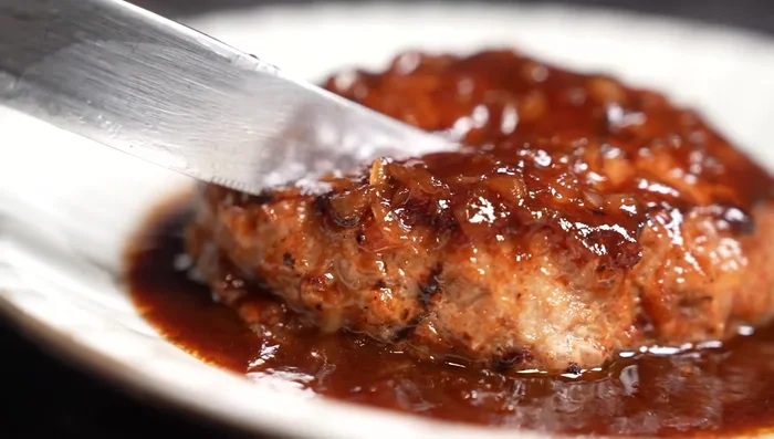 Pour the sauce over the hamburger steaks.