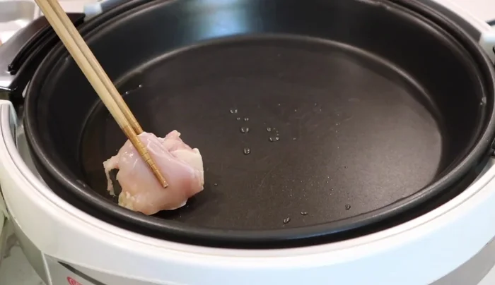 Heat a pan at medium-high heat with oil and sear the chicken until browned.