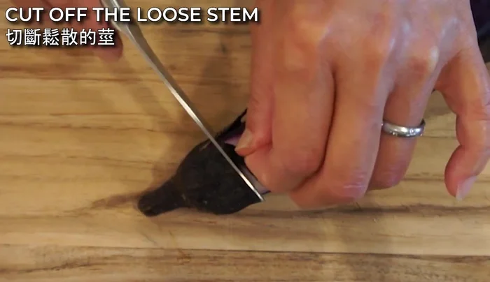 Cut around the stem area of the eggplant, but don't remove the stem completely. Only cut the loose part.