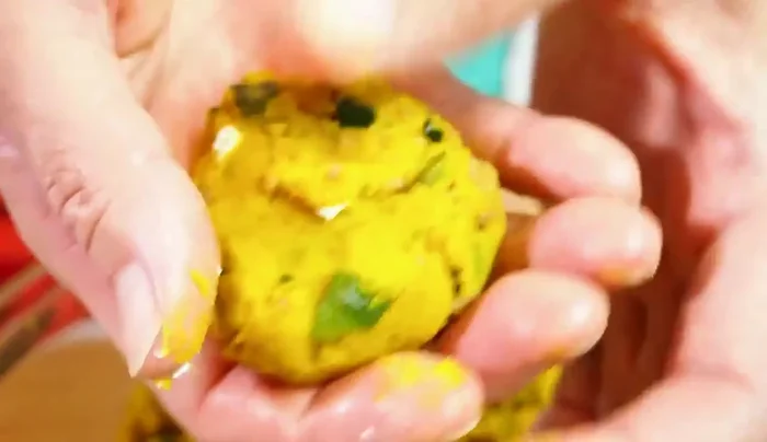 Place cream cheese in the indent, cover with more pumpkin mixture, and gently mold back into a ball.