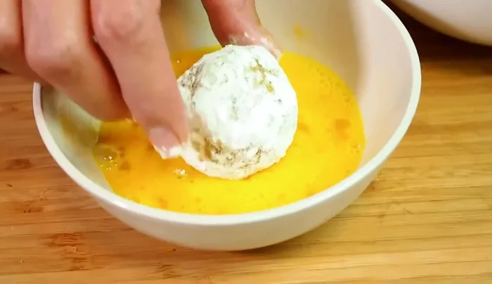 Dredge each pumpkin ball in flour, then egg wash, then panko breadcrumbs, ensuring full coverage.