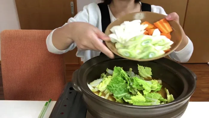 Add soup base, vegetables, and chicken to the hot pot.