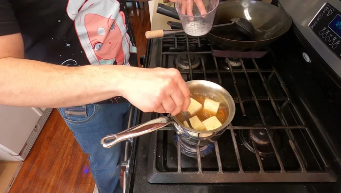 Thicken the sauce: Slowly add the slurry to the broth, stirring constantly, until it reaches a syrupy consistency.