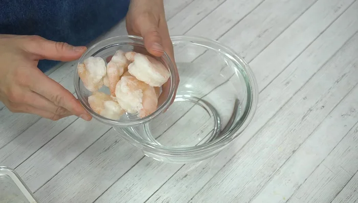 Thaw frozen shrimp in salt water (approx 1/2 tsp salt in water). This firms the shrimp.