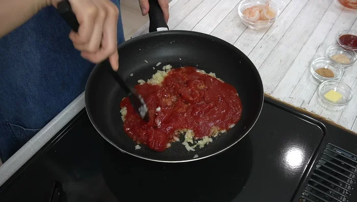 Add canned tomatoes and crush while heating to reduce moisture and concentrate flavor.