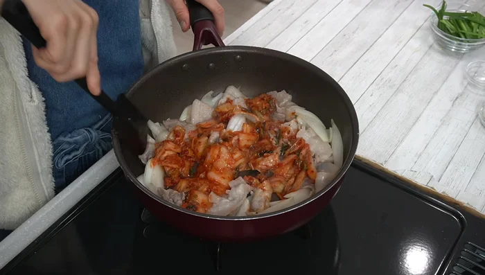 Add kimchi and stir-fry thoroughly.